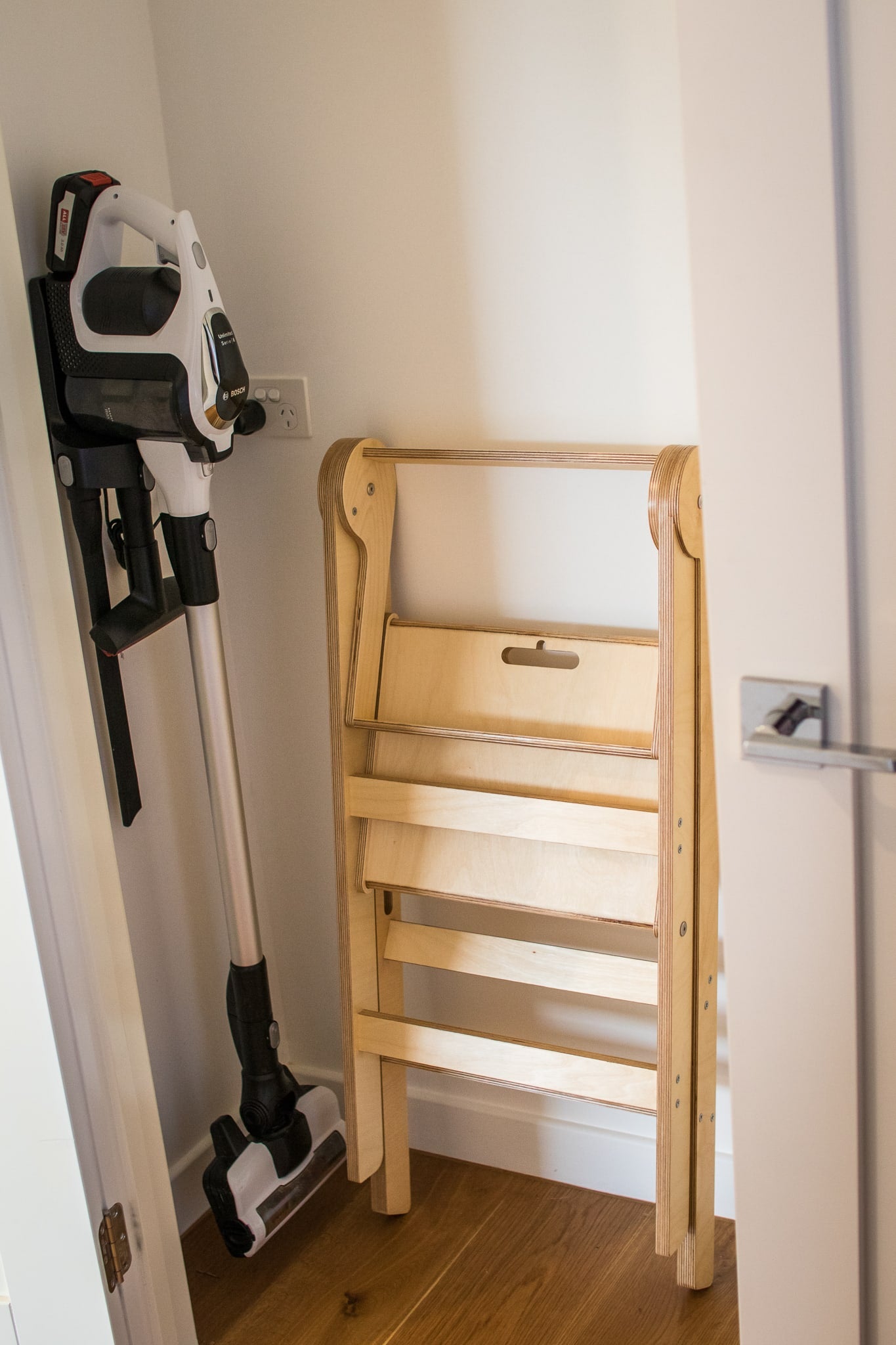 Folding Learning Tower depicted folded in storage cupboard