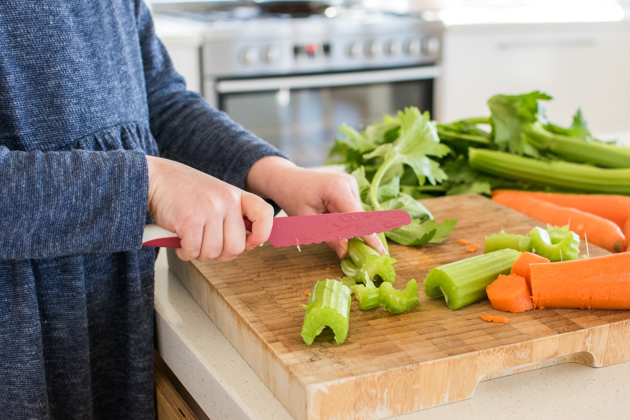 Child cooking with kid safe knife