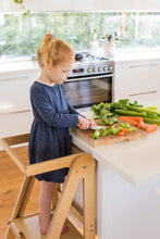 Load image into Gallery viewer, Kids cooking in the kitchen on a Folding Learning Tower
